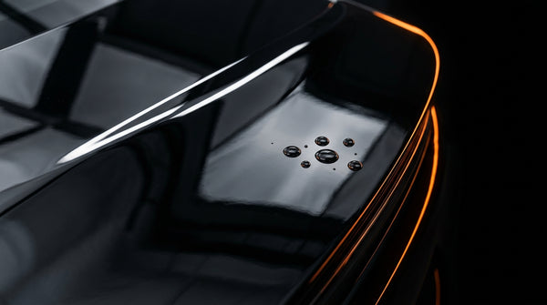 AUREON Clear Gloss PPF: high-gloss film over black paint with water beading